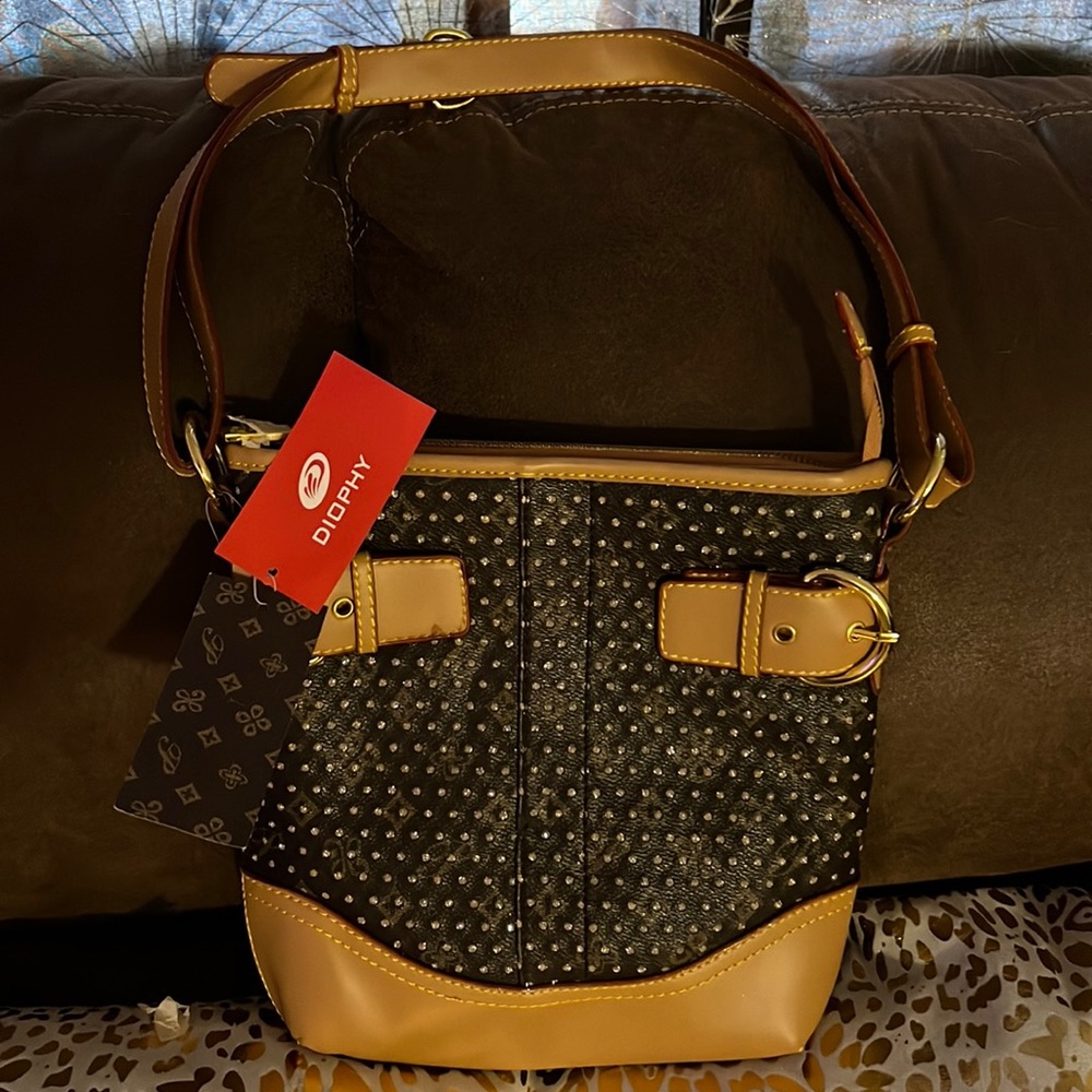 Selling a beautiful Diophy crossbody purse. It does have some bling bling to it.